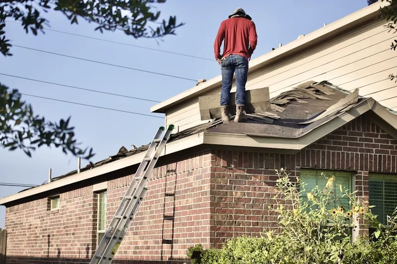 Professional roofer working on a residential roof in West Friendship
